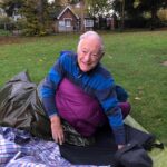 Smiling man sleeping out