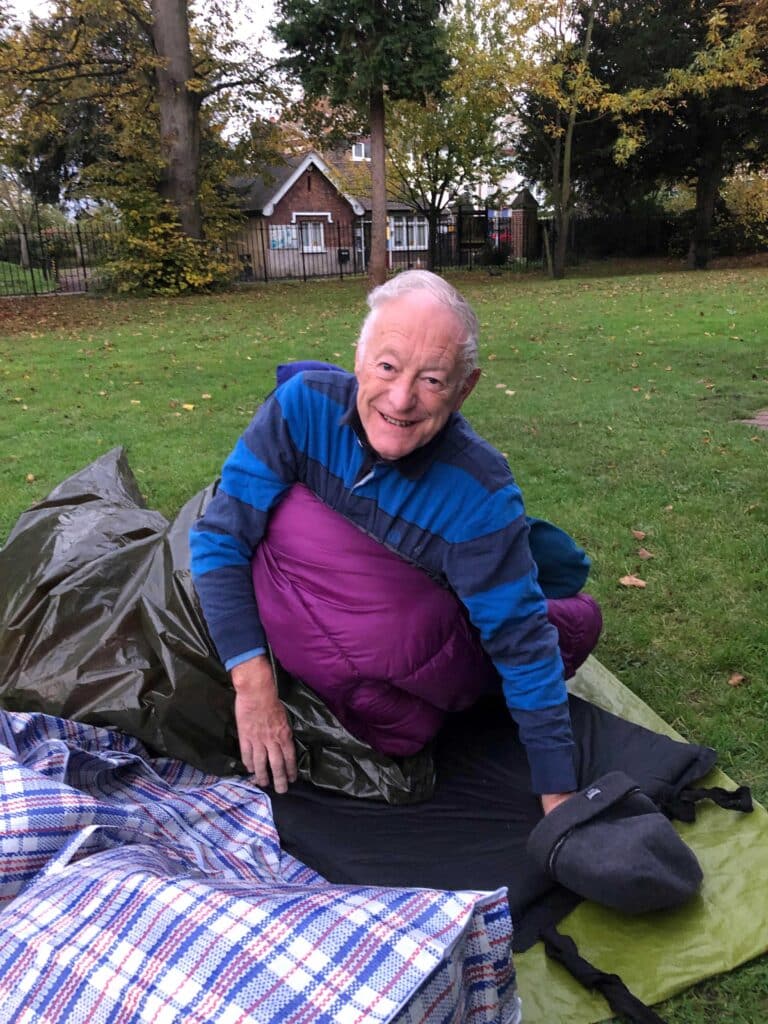 Smiling man sleeping out